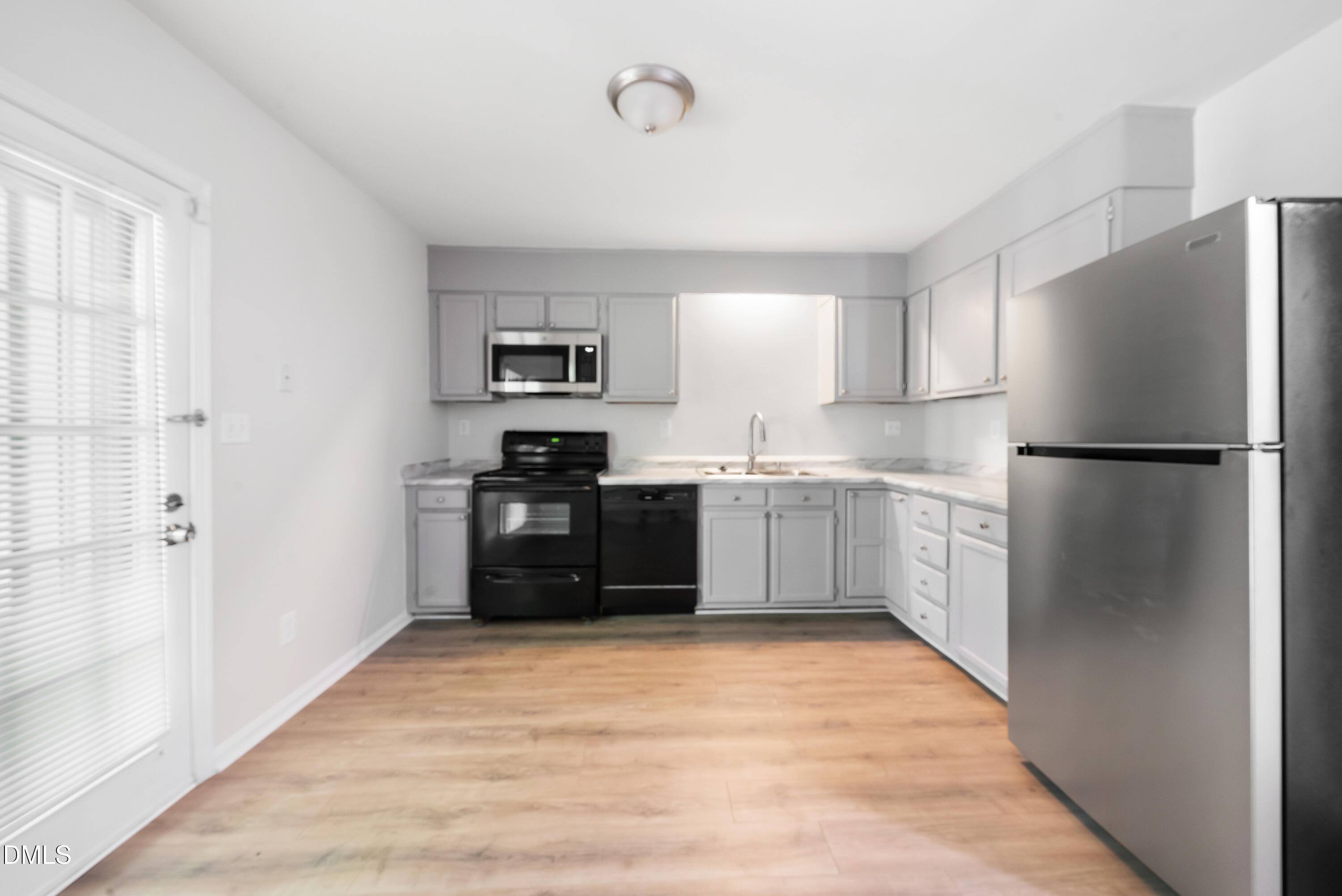 7927 Brown Bark Place Raleigh, NC 27615 - Photo 12 of 25 a kitchen with stainless steel appliances granite countertop a refrigerator and a stove top oven