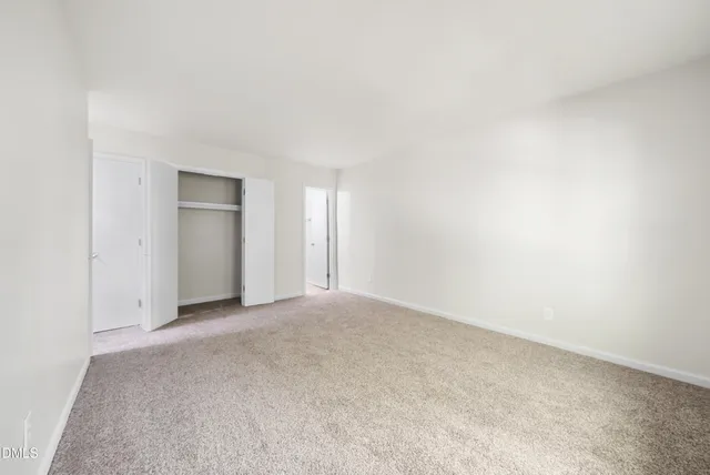 a view of an empty room and closet