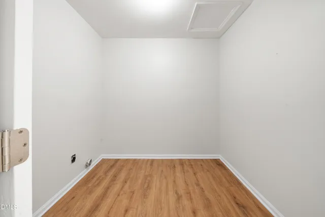 a view of a room with wooden floor