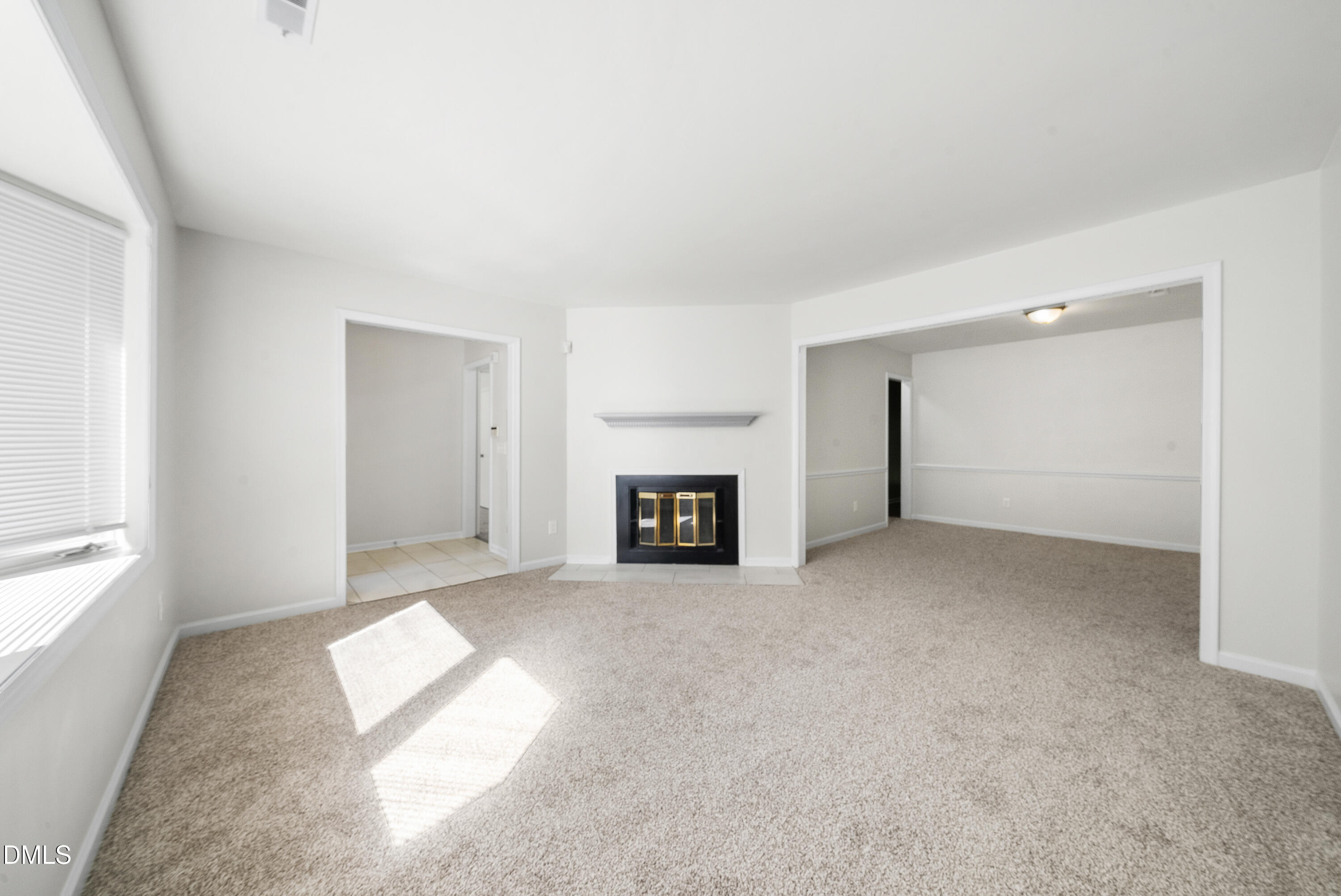 7927 Brown Bark Place Raleigh, NC 27615 - Photo 3 of 25 a view of a livingroom with a fireplace and window