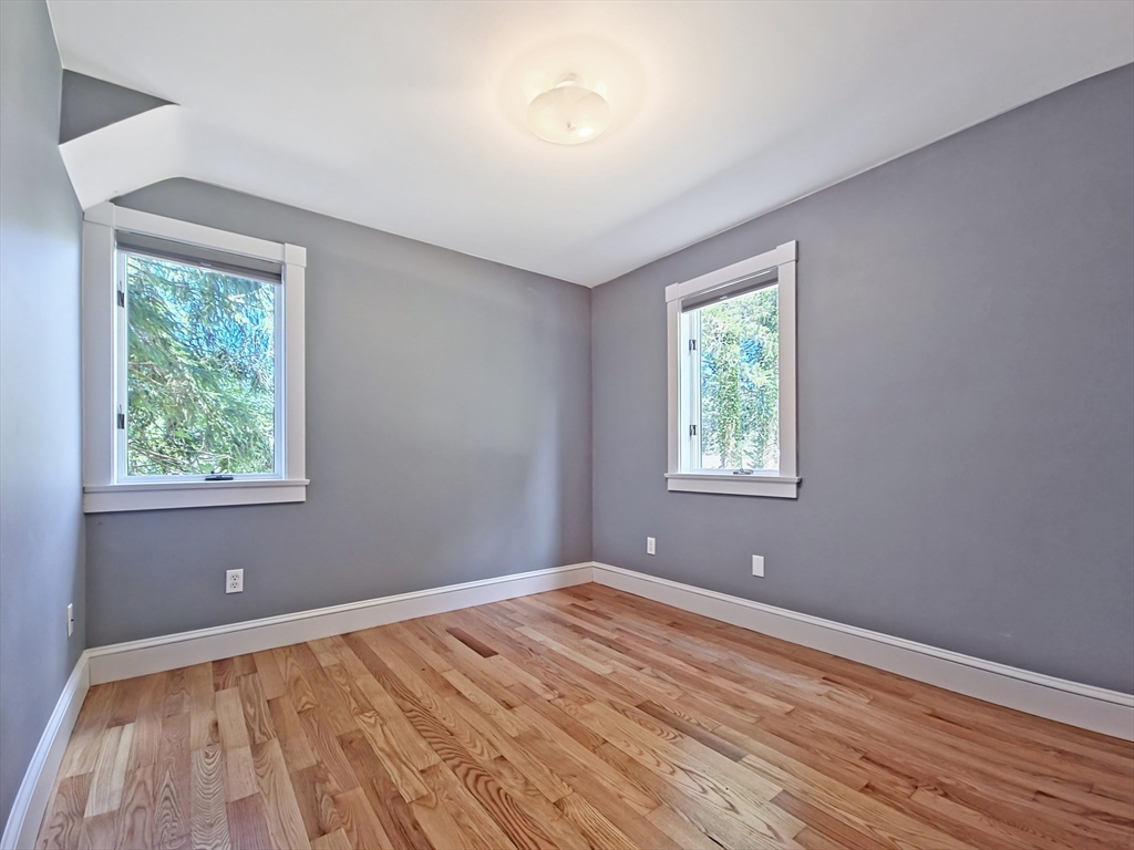 10 Squeteague Harbor Road Bourne, MA 02534 - Photo 16 of 41 a view of an empty room with wooden floor and a window
