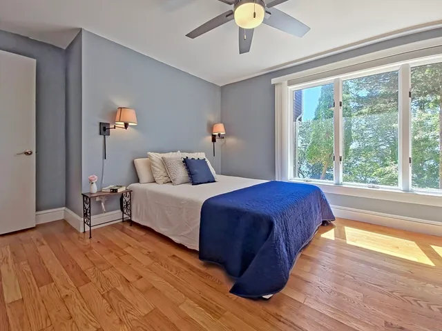 a bedroom with a large bed and a large window