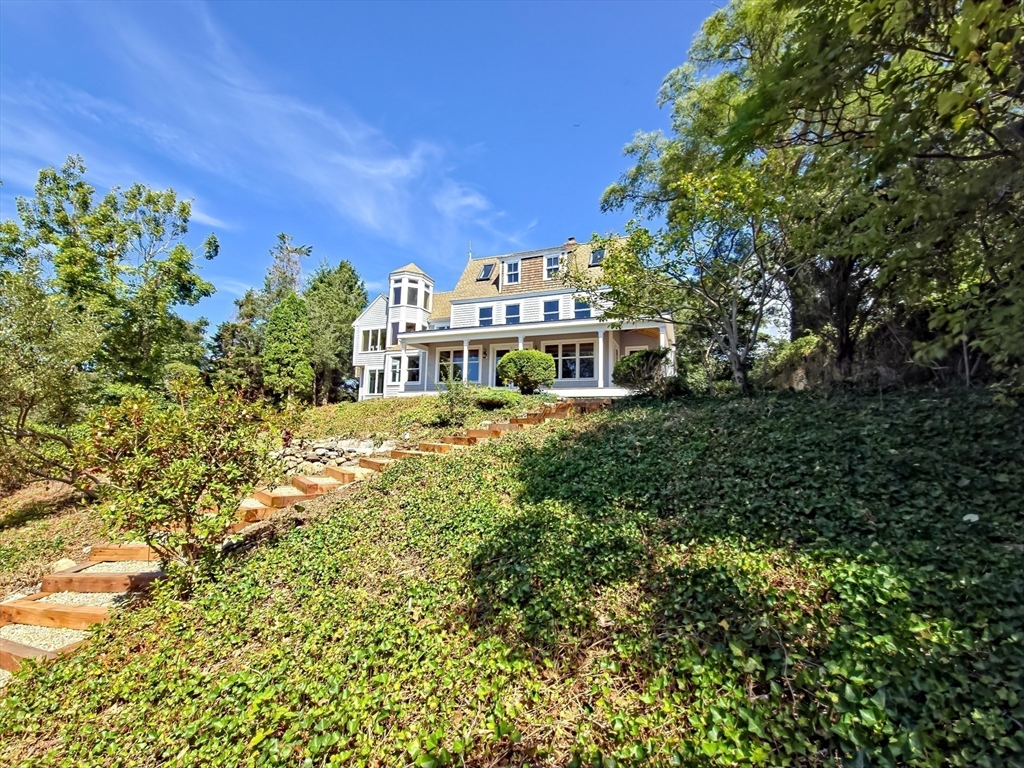 10 Squeteague Harbor Road Bourne, MA 02534 - Photo 2 of 41 a view of a big yard with plants and large trees