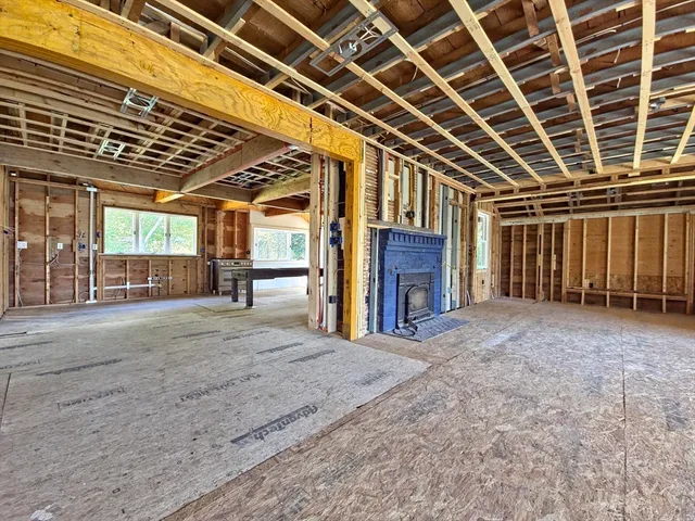 a view of an empty room with a fireplace