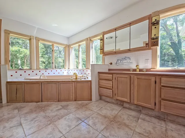 a kitchen with a sink and large window