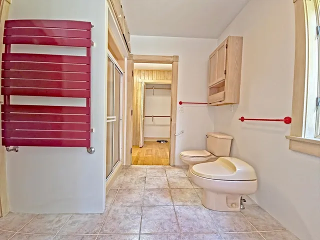 a bathroom with a toilet and a shower