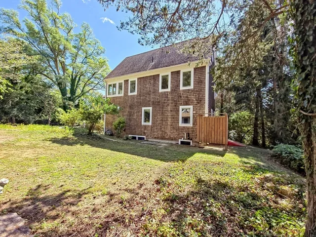 a view of a house with backyard and sitting area