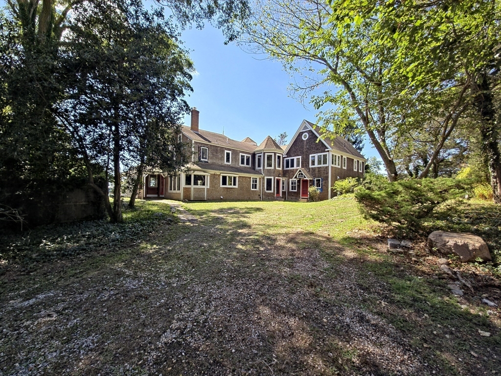 10 Squeteague Harbor Road Bourne, MA 02534 - Photo 5 of 41 a front view of a house with a yard