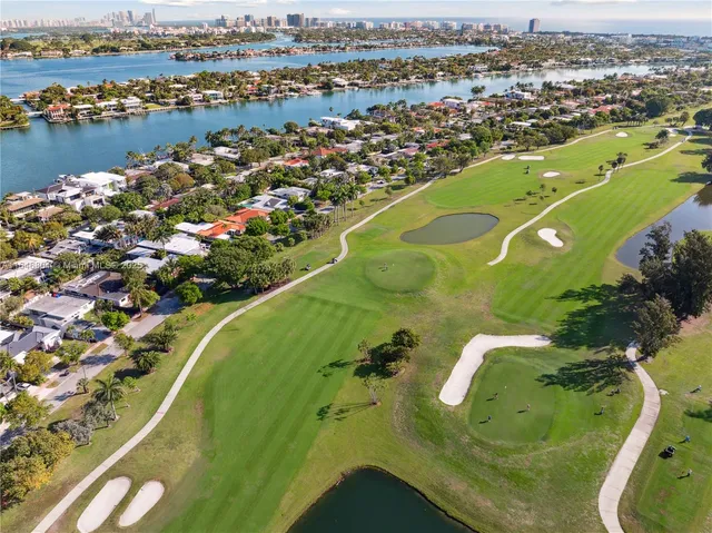 an aerial view of residential houses with outdoor space and swimming pool