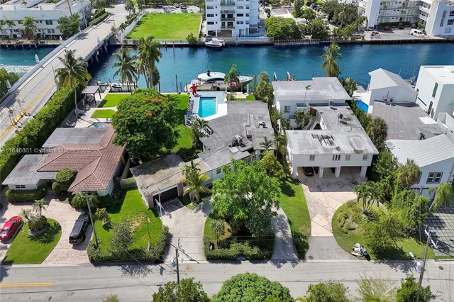 an aerial view of a house with a garden and swimming pool