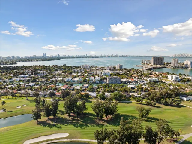 a view of a city with lots of residential buildings and ocean