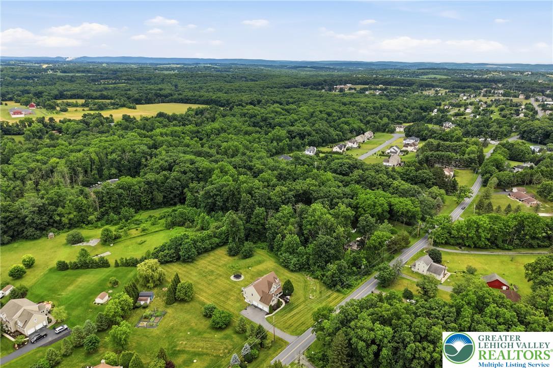 1212 Miller Road Wind Gap, PA 18091 - Photo 71 of 72 An aerial panorama showcases a verdant, expansive residential landscape with winding roads and scattered homes.