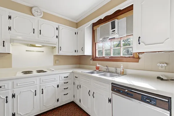 a kitchen with stainless steel appliances white cabinets and a sink
