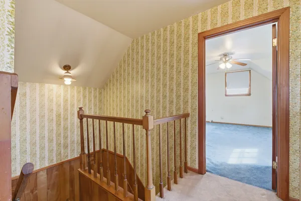 a view of a hallway with a door and a mirror