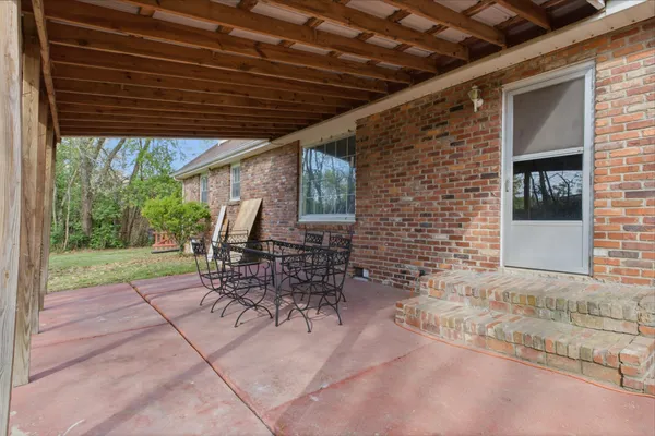 a patio with table and chairs