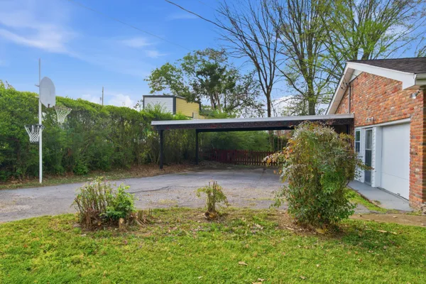 a backyard of a house with table and chairs