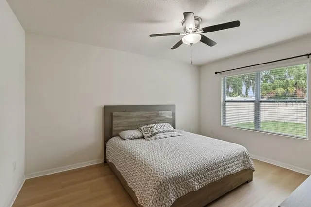 a bedroom with a bed and window