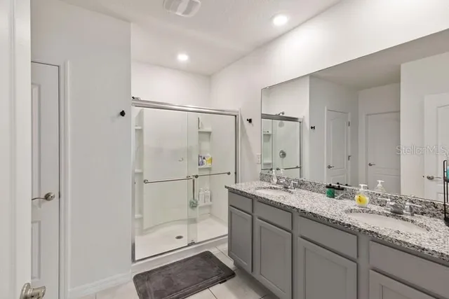 a bathroom with a granite countertop sink mirror and double