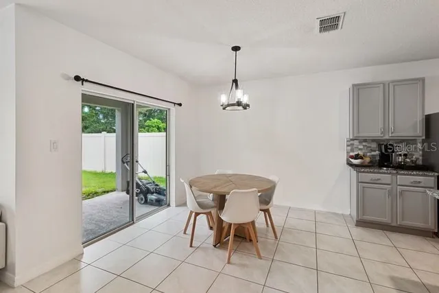 a view of a dining room with furniture and a chandelier