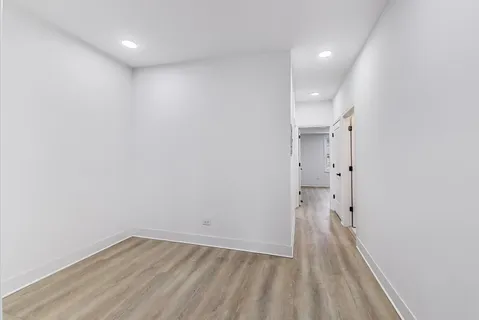 a view of a room with wooden floor