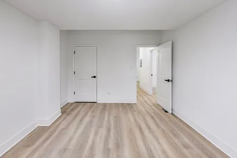 a view of a room with wooden floor