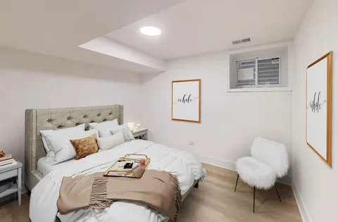 a bedroom with a bed and a chair