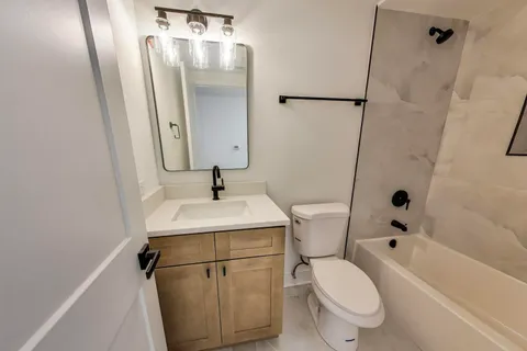 a bathroom with a sink toilet and shower