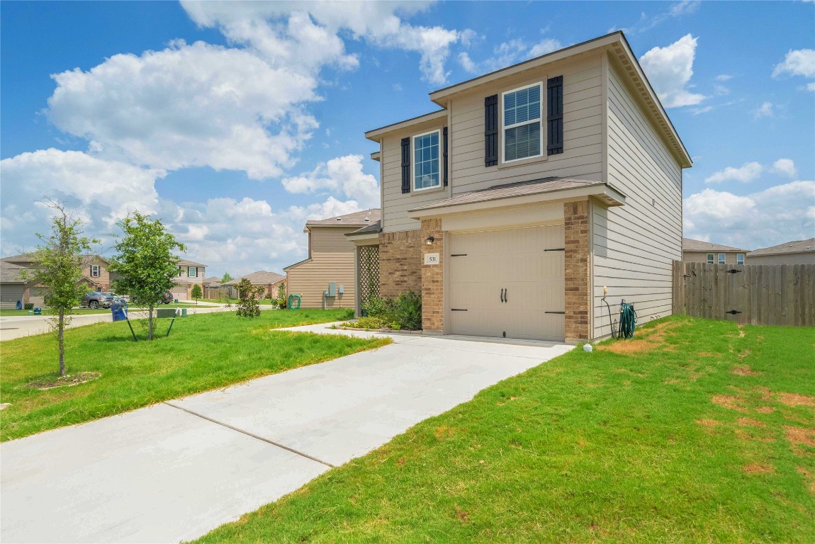 a front view of a house with a yard and garage