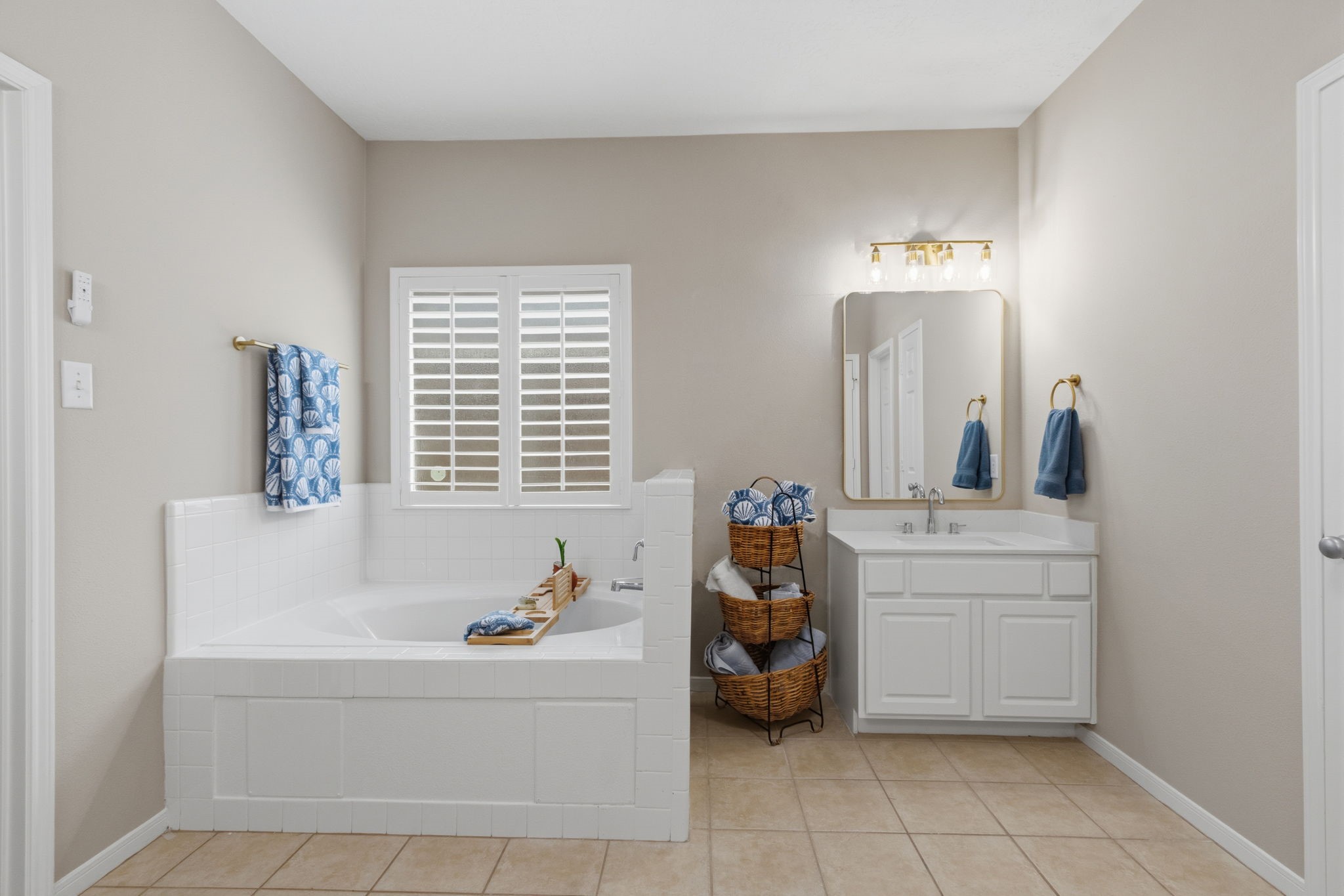 8419 Marchelle Lane Spring, TX 77379 - Photo 12 of 42 a bathroom with a tub sink and mirror