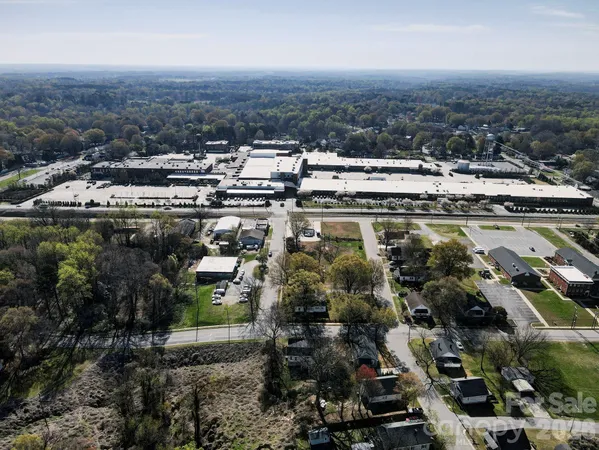 an aerial view of residential houses with city view