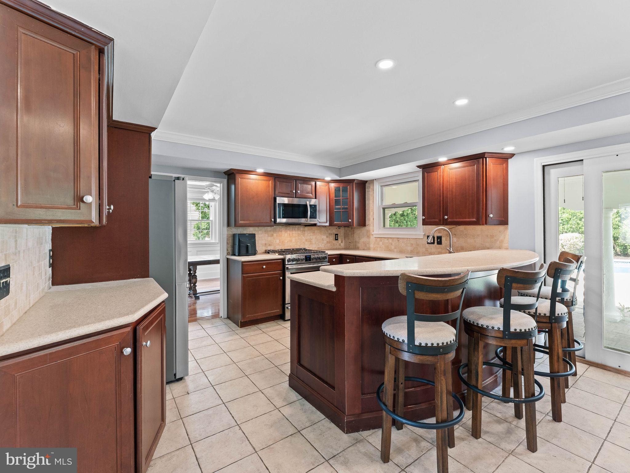 8 Chesterfield Road Sewell, NJ 08080 - Photo 15 of 57 a kitchen with stainless steel appliances granite countertop a stove a sink a microwave and a refrigerator