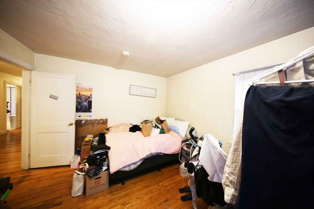 23 Heath Street, Unit 1 Brookline, MA 02445 - Photo 11 of 16 a bedroom with furniture and wooden floor