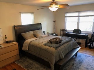 23 Heath Street, Unit 1 Brookline, MA 02445 - Photo 12 of 16 a bedroom with a bed table chair and a window