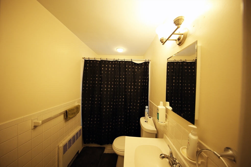 23 Heath Street, Unit 1 Brookline, MA 02445 - Photo 16 of 16 a bathroom with a sink and mirror
