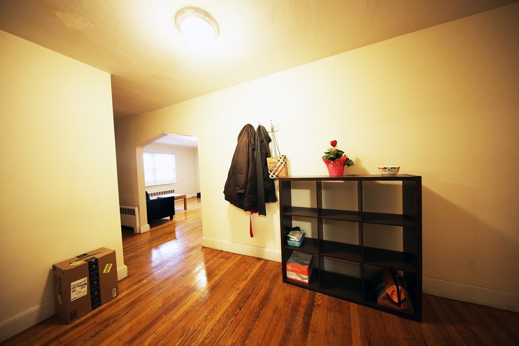 23 Heath Street, Unit 1 Brookline, MA 02445 - Photo 3 of 16 a view of a living room and wooden floor