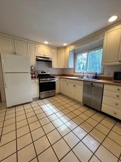 23 Heath Street, Unit 1 Brookline, MA 02445 - Photo 6 of 16 a kitchen with stainless steel appliances granite countertop a stove a sink and a refrigerator