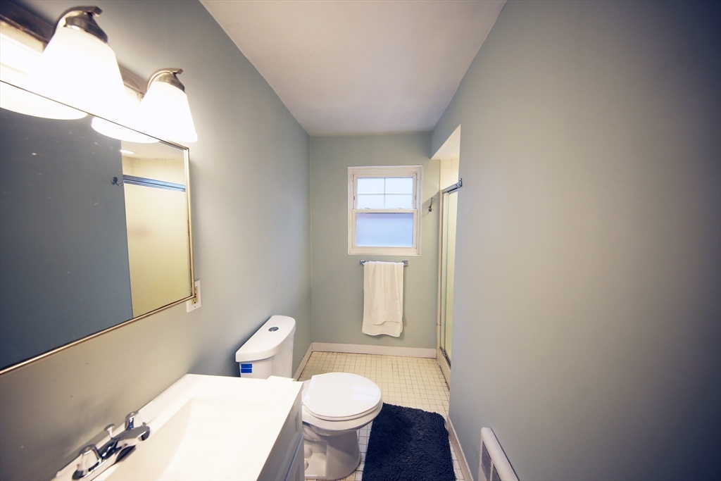 23 Heath Street, Unit 1 Brookline, MA 02445 - Photo 9 of 16 a white toilet sitting next to a bathroom sink