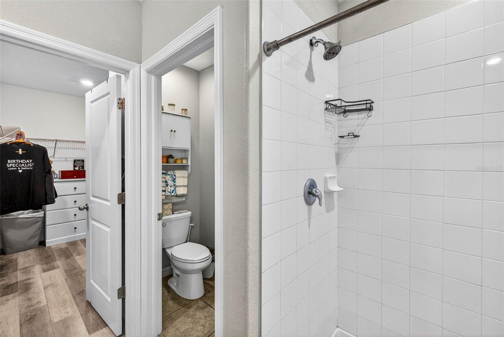 9616 Lemon Drop Loop Sun City Center, FL 33573 - Photo 25 of 53 a bathroom with a shower toilet and sink