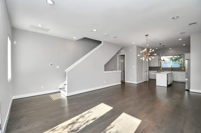 a view of a living room a kitchen and a sink