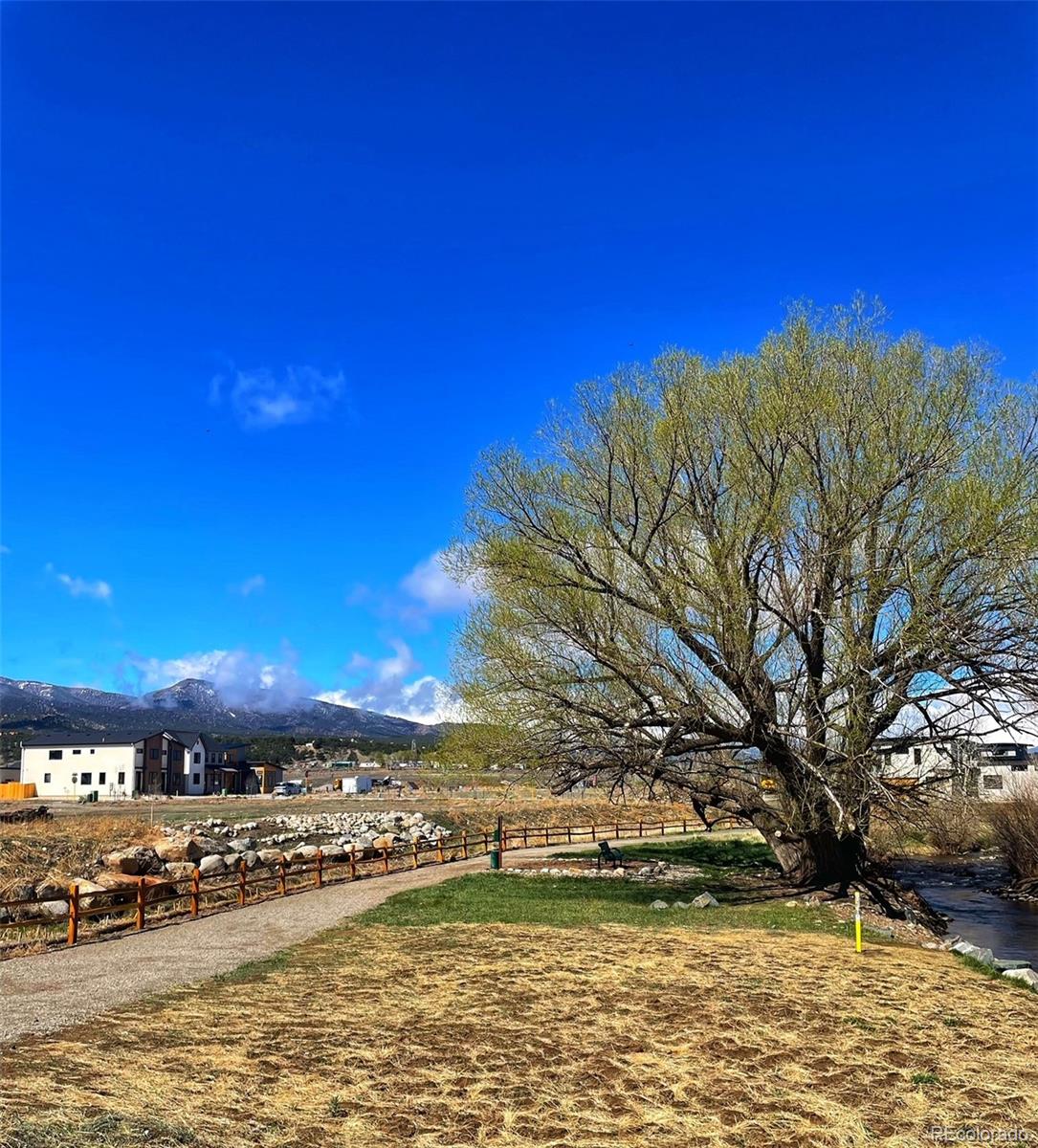 306 Southside Loop Salida, CO 81201 - Photo 18 of 37 a view of a large pool with lawn chairs under an umbrella