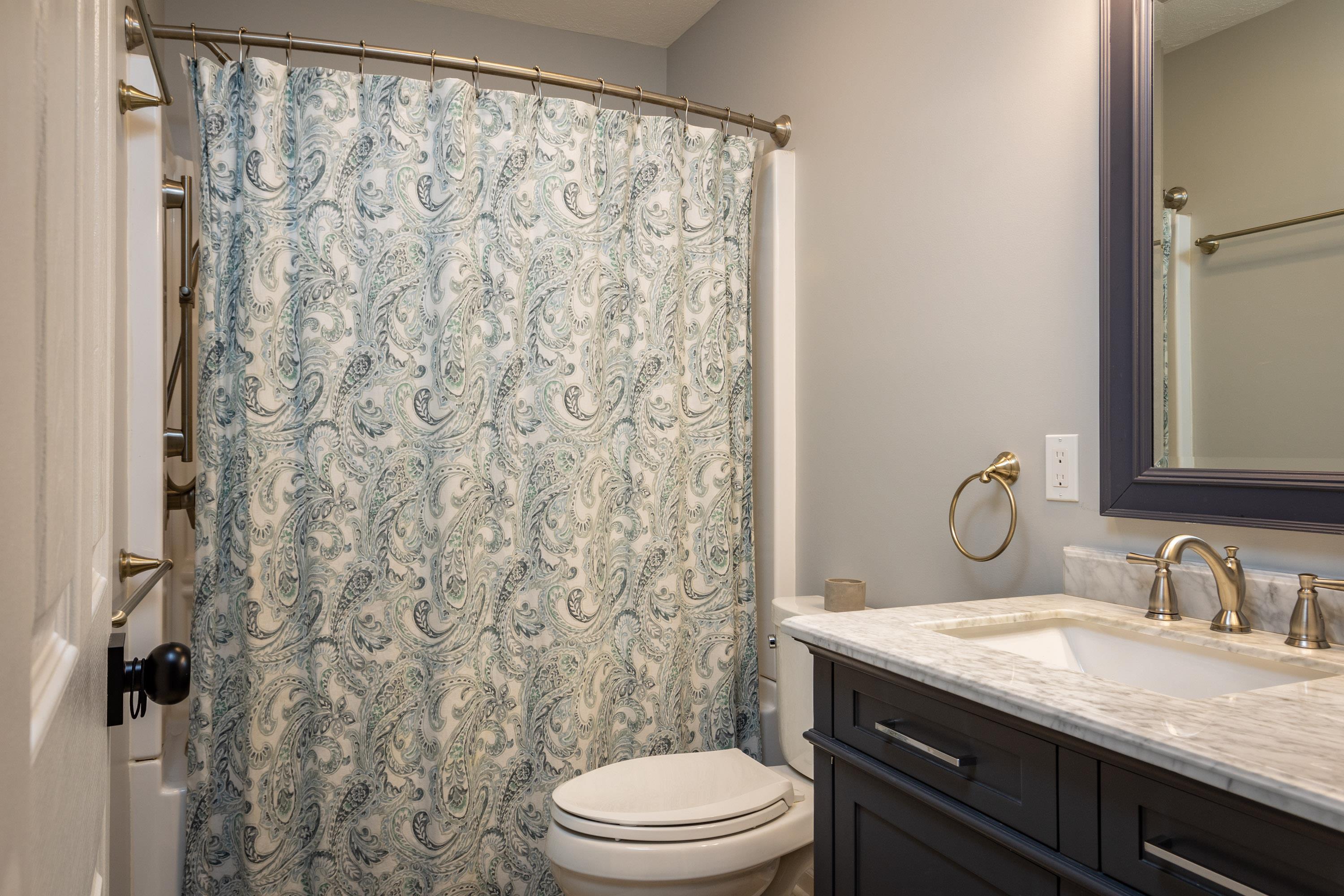 3850 Davis Road Penn Laird, VA 22846 - Photo 40 of 70 a bathroom with a granite countertop sink toilet a mirror and shower curtain