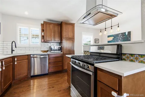 a kitchen with a stove a sink and a microwave