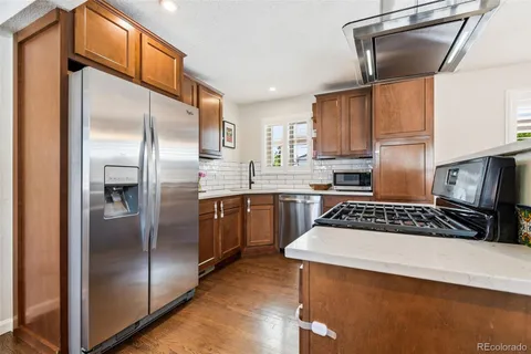 a kitchen with a refrigerator sink and cabinets
