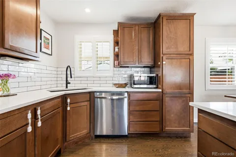 a kitchen with a refrigerator sink and cabinets