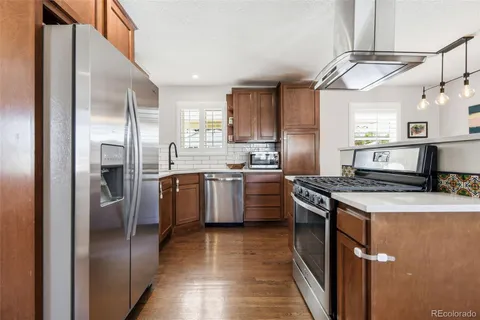 a kitchen with a stove sink and refrigerator