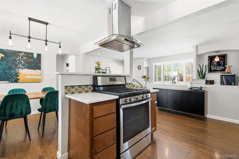 a kitchen with stainless steel appliances granite countertop a stove and a refrigerator