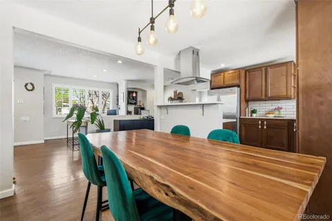 a kitchen with kitchen island a table and chairs in it