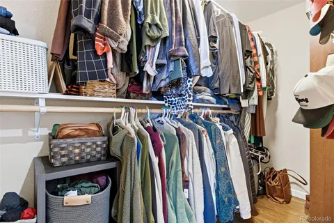 a view of walk in closet with clothes