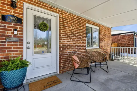 a balcony with furniture and a potted plant