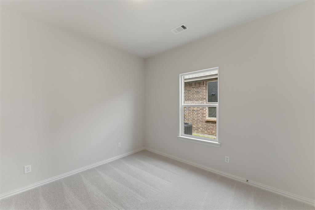 3504 Helena Street Gainesville, TX 76240 - Photo 13 of 19 Neutral-toned interior room with light gray carpeting and white baseboards